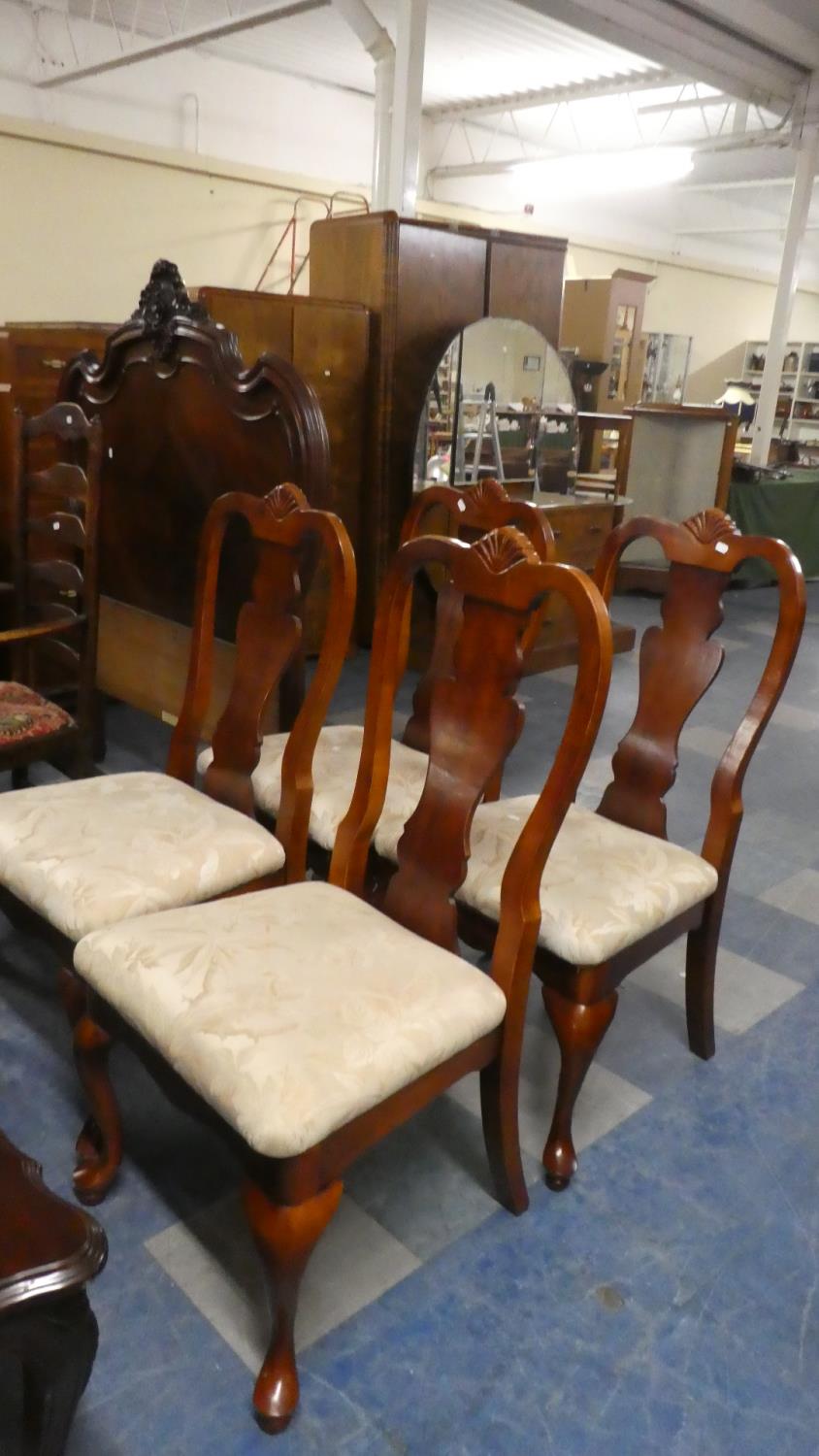 A Set of Four Mahogany Queen Anne Style Dining Chairs with Cabriole Front Legs