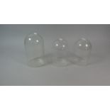 A Collection of Three Glass Domes, 18.5cm and 15.5cm