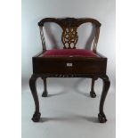 A reproduction Mahogany Framed Piano Stool in the Manor of Chippendale on Cabriole Supports with