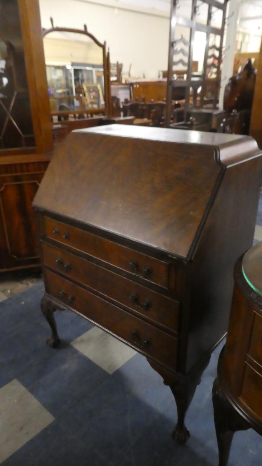 An Edwardian Fall Front Bureau with Fitted Interior, Three Long Drawers and Cabriole Supports with