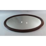 An Edwardian Mahogany Oval Wall Mirror, 66cm Wide