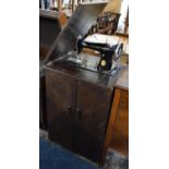 An Edwardian Oak Cabinet Containing Singer Sewing Treadle Sewing Machine, With Instruction Book