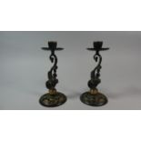 A Pair of Reproduction Bronze Effect Candle Sticks with Pierced Circular Bases and Fish Supports,