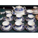 A Wedgwood Blue Siam Tea Set Comprising Six Trios, Teapot, Bread and Butter Plate, Cream and Sugar