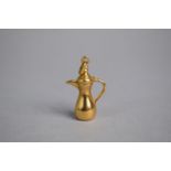 A 9ct Gold Charm, Modelled as a Turkish Ewer or Coffee Pot. 2.9gms