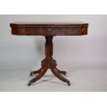 A 19th Century Mahogany Tea Table set on Spiralled Support with Brass Claw Casters. 92x45x74cms when