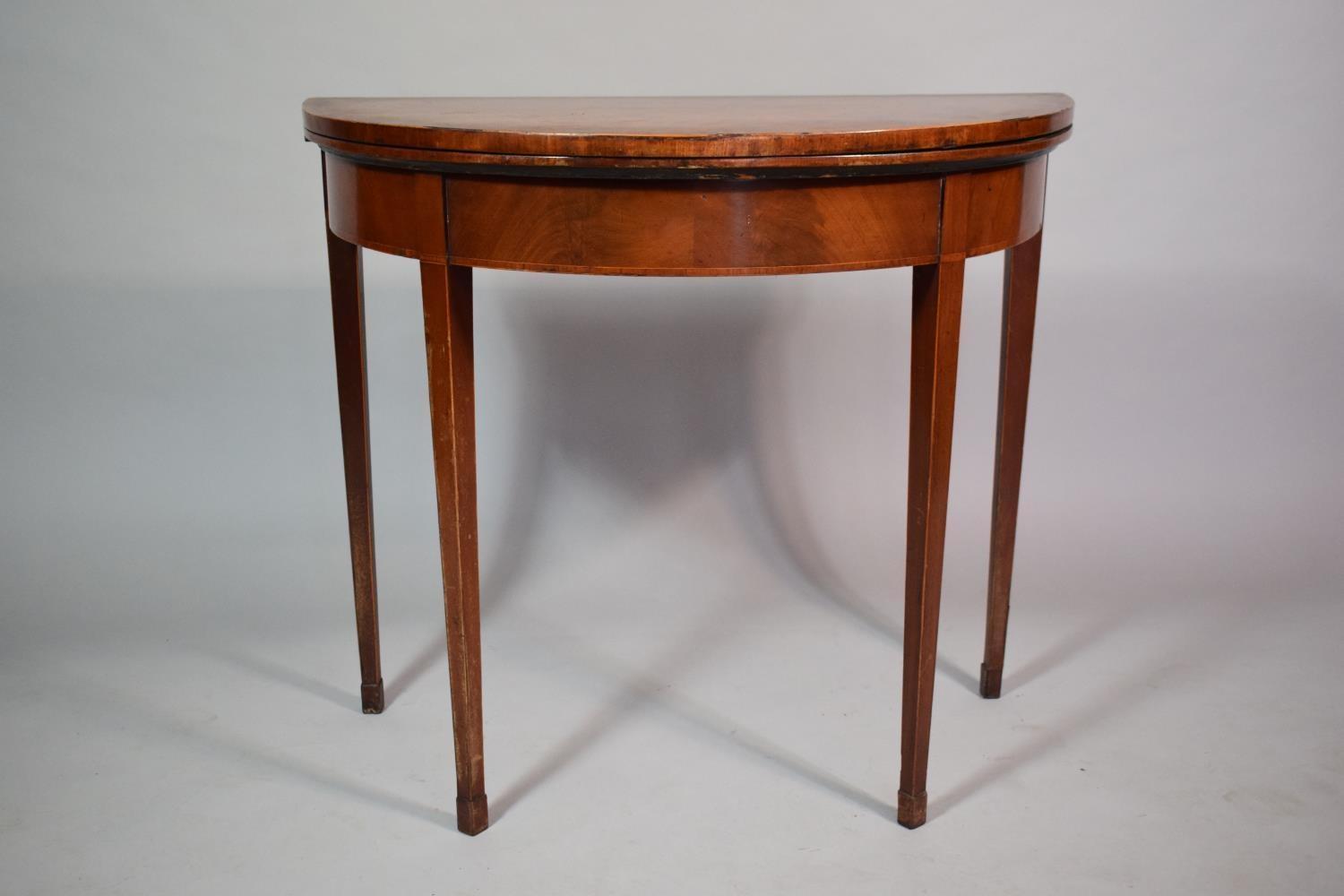 A Mahogany String Inlaid Georgian Games Table with Beize Top and Supported on Tapered Legs. 84cms