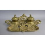 A Reproduction French Style Brass Ink Stand with Pen Rest and Two Ceramic ined Ink Wells, 34cms Wide