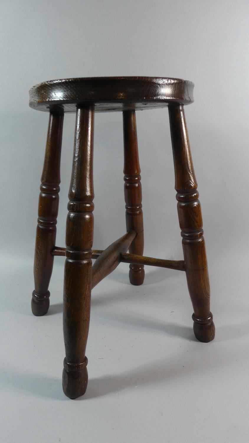 A 19th Century Ash and Beech Factory Stool with Solid Seat Over Turned Legs and Stretchers. 46cm
