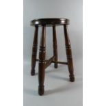 A 19th Century Ash and Beech Factory Stool with Solid Seat Over Turned Legs and Stretchers. 46cm