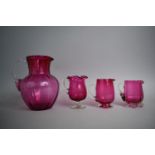 A Collection of Four Victorian/Edwardian Cranberry Glass Jugs