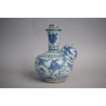 An Early Chinese Blue and White Glazed Earthenware Kendi. 19.5cms High (Chips to Rim and Spout)