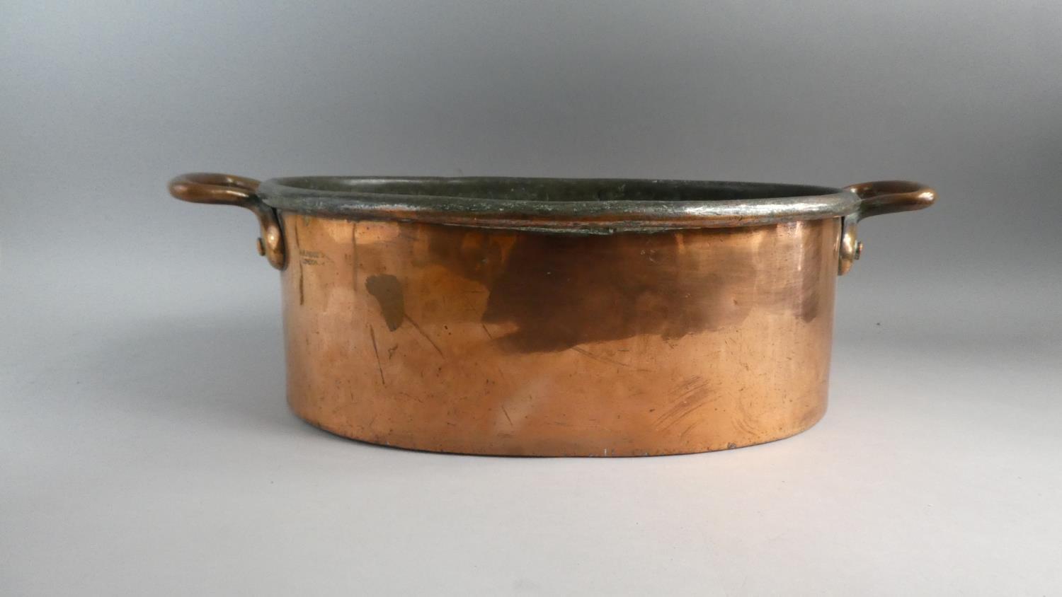 A Large and Heavy Victorian Copper Oval Two Handled Cooking Pan. 62cms Wide