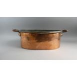 A Large and Heavy Victorian Copper Oval Two Handled Cooking Pan. 62cms Wide