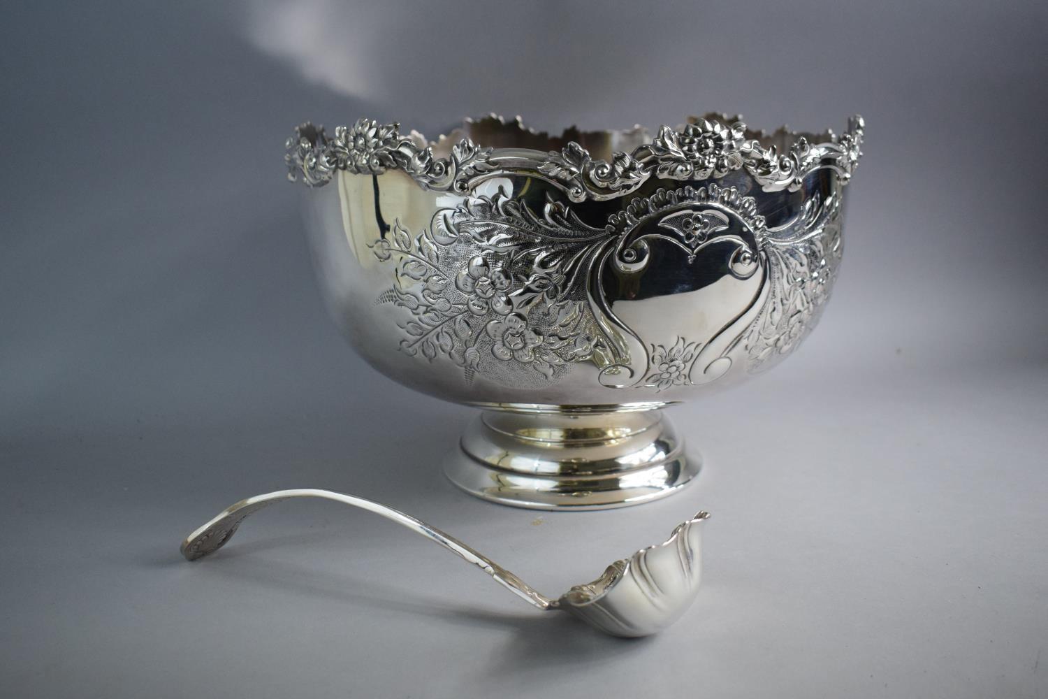 A Large Silver Plated Punch Bowl with Hand Chased Repousse Decoration and Circular Foot. 36cms