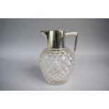 A Cut Glass Water Jug with Silver Pourer and Hinged Lid. 19cms High. Birmingham Hallmark