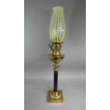 A Victorian Brass Oil Lamp with Ebonised Corinthian Column Support on Square Base. Yellow Vaseline
