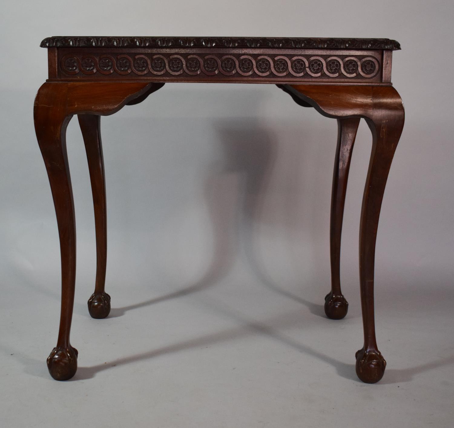 A Mahogany Silver Table with Carved Border set on Cabriole Legs culminating in Claw and Ball Feet,