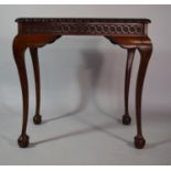 A Mahogany Silver Table with Carved Border set on Cabriole Legs culminating in Claw and Ball Feet,
