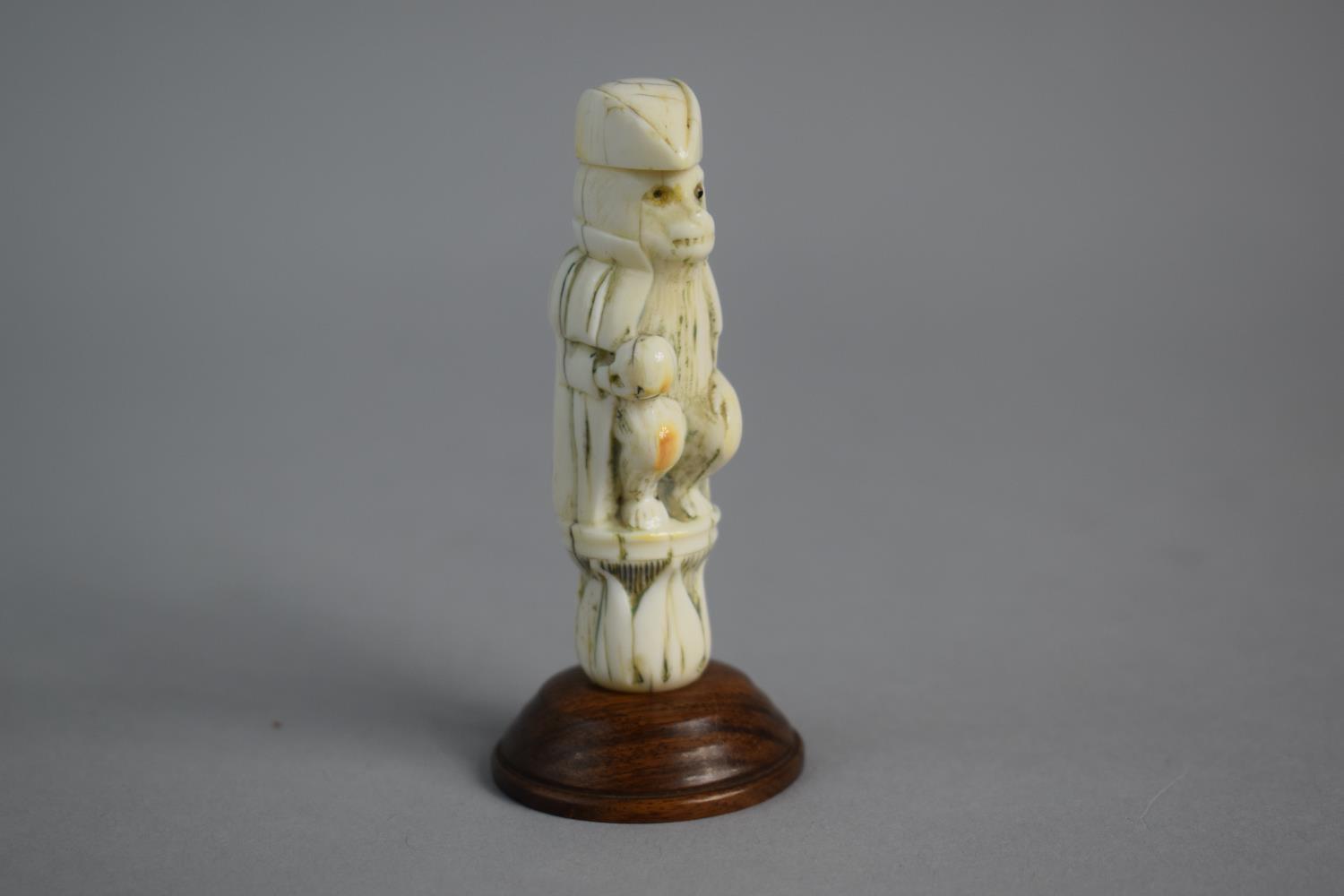 A 19th Century Carved French Ivory Novelty in the Form of Seated Metamorphic Monkey Wearing Cloak