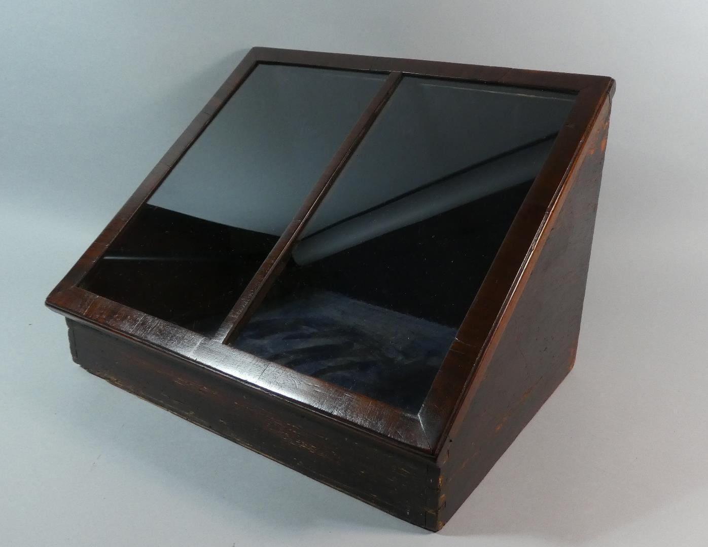 A 19th Century Mahogany Shop Counter Display Cabinet with Glazed Slanted Top Over a Grained