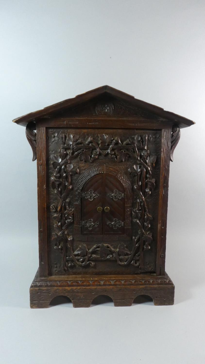 A 19th Century Black Forest Carved Linden Wood Table Cabinet. 40cm x 19cm x 59cm High