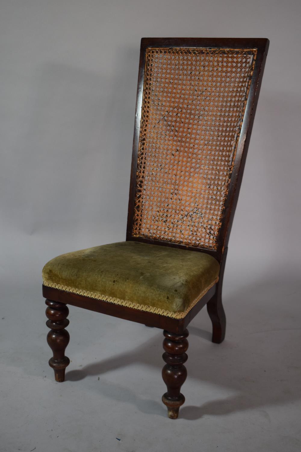 A Victorian Mahogany Framed Nursing Chair with Cane Back and Upholstered Seat with Front Turned