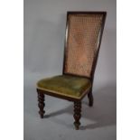 A Victorian Mahogany Framed Nursing Chair with Cane Back and Upholstered Seat with Front Turned