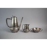 A Polished Pewter Three Piece Art Nouveau Coffee Service by Hutton, Sheffield.