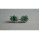 A Pair of Emerald and Diamond Stud Earrings. Cushion Cut Emeralds 6mmx4mm.