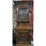 A Continental Carved Oak Gothic Style Double Freestanding Cabinet with Carved Decoration having