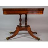 A Mid 19th Century Crossbanded Rosewood Lift and Twist Games Table with Turned Supports and Four