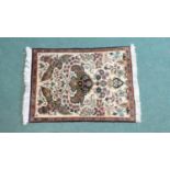 A Persian Hand Made Silk Qum Rug. 77x56cms
