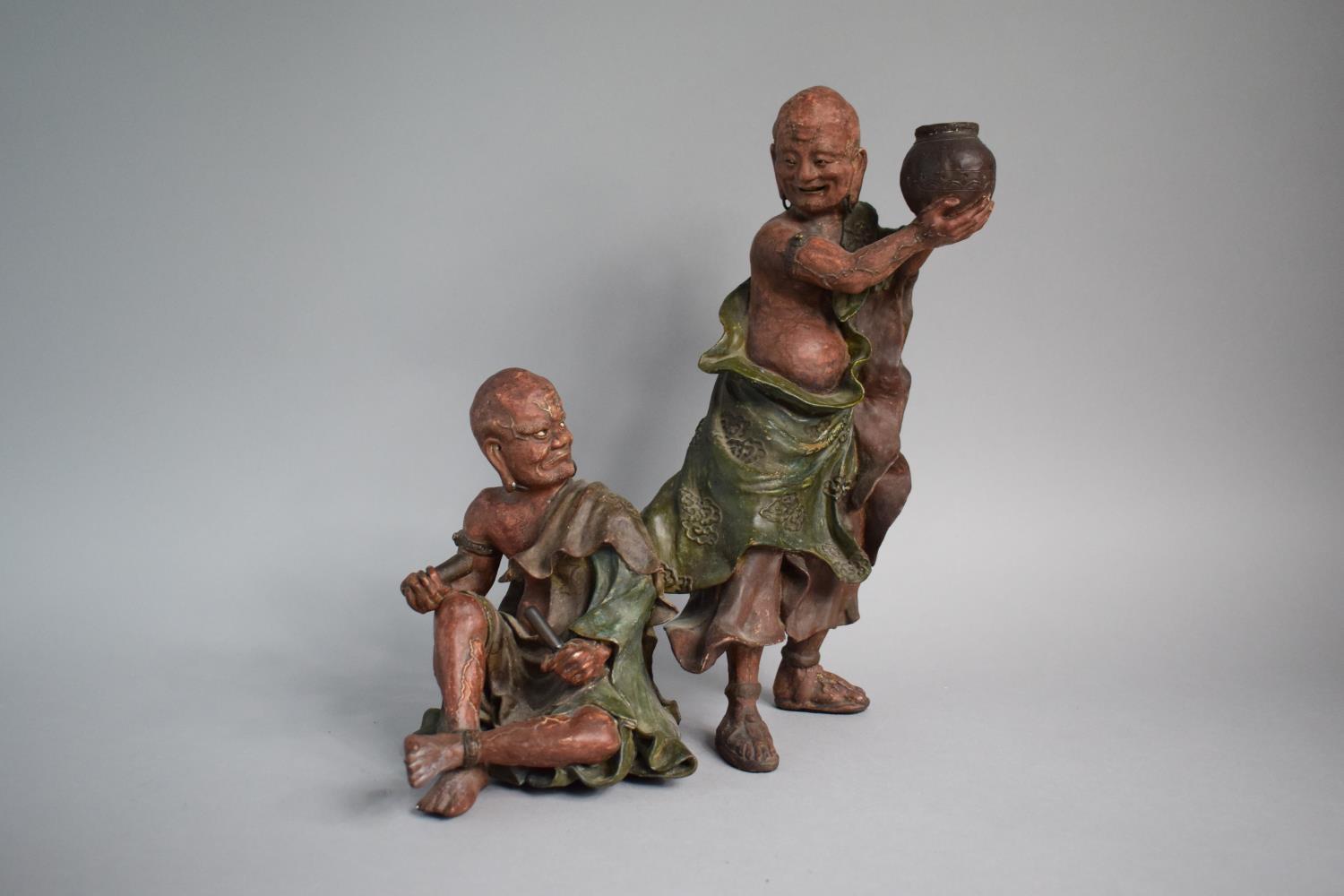 A Japanese Terracotta Figure Group, Monk Teasing Seated Scribe. 30.5cms High