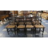 A Set of Eight Rush Seated Spindle Back Dining Chairs Including Two Carvers