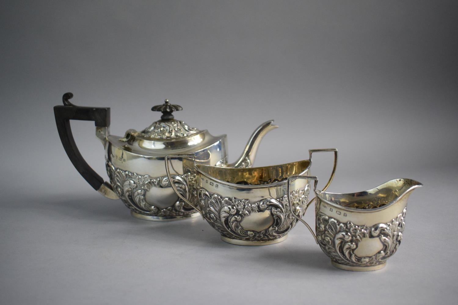 A Silver Three Piece Bachelor's Tea Service with Repousse Decoration, Birmingham 1900