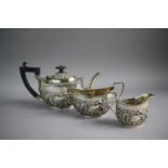 A Silver Three Piece Bachelor's Tea Service with Repousse Decoration, Birmingham 1900