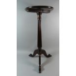An 18th Century George III Mahogany Kettle Stand with Dished Top Over Reeded Column and Tripod Legs.