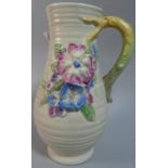 A Clarice Cliff Jug with Floral Relief Decoration, 21cm High