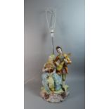 A Large Naples Ceramic Figural Table Lamp, Musician and Lady with Fan, Total height 96cm
