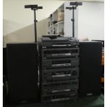 An Akai Stereo System with Speakers on Adjustable Stands