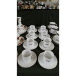A Set of Eight Floral Patterned Royal Worcester Coffee Cans and Saucers