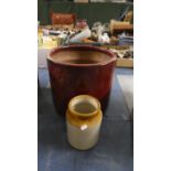 A Red Glazed Cylindrical Planter and a Treacle Glazed Jar, Planter 37cm Diameter
