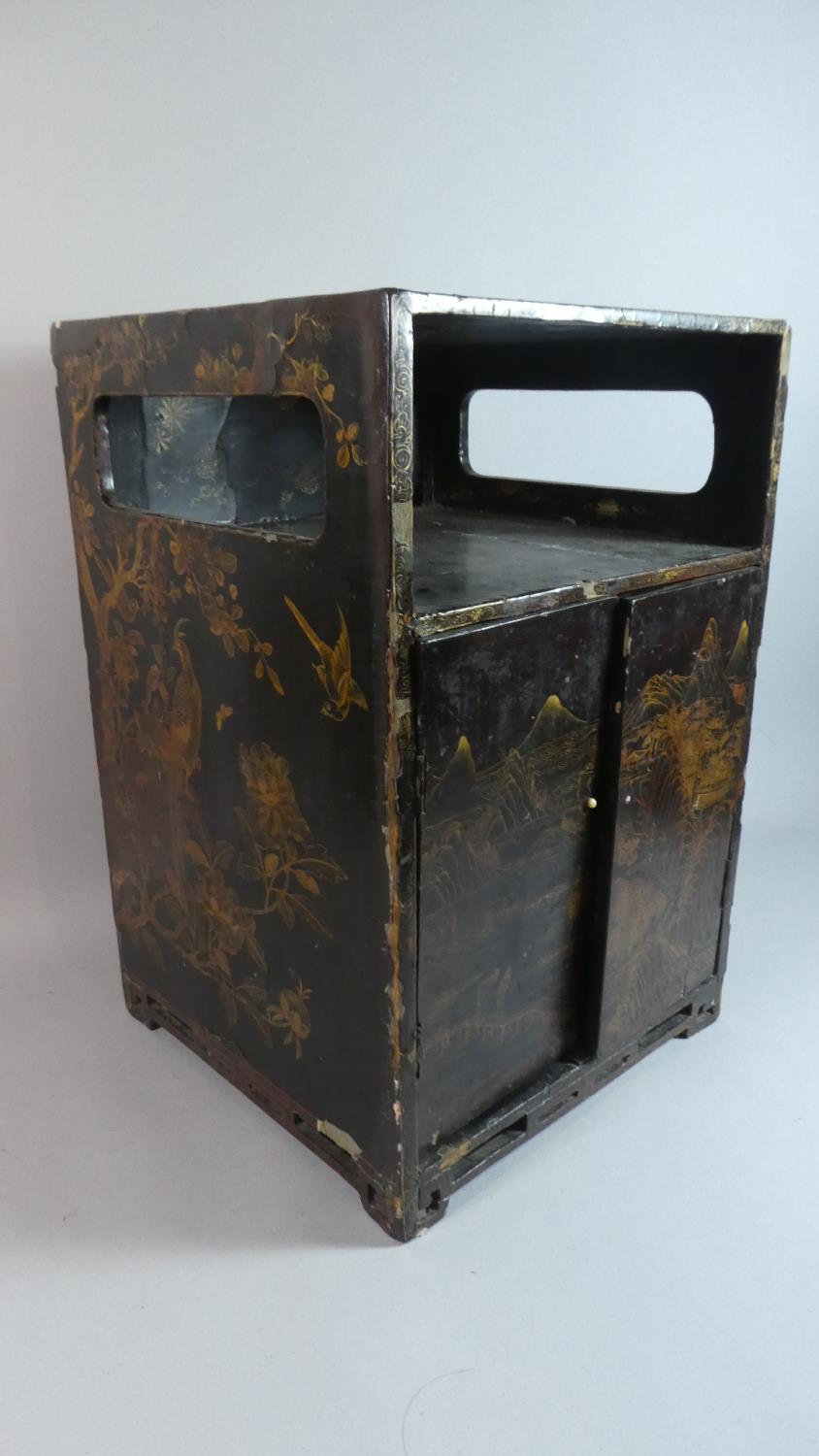 An Early Chinese Lacquered Cabinet with Gilt Decoration Depicting Mountain Scenes, Birds and