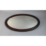 An Edwardian Mahogany Framed Oval Wall Mirror, 61cm high