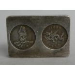 A Small Oriental White Metal Rectangular Token with Two Impressed Coins and Mark to back with