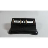 A Black Bakelite Desk Top Calendar by Stratton, 11cm Wide