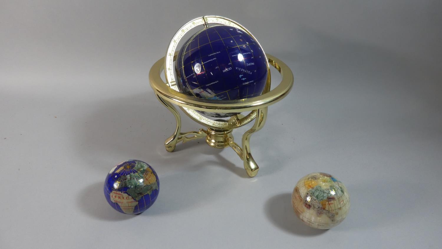 A Modern Brass Framed Specimen Table Globe, 25cm high and Two Miniature Free Standing Globes, Each