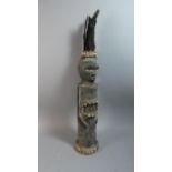 A Coastal Tribal Carved Wooden Figure Decorated with Shells and Feathers, 65cm High