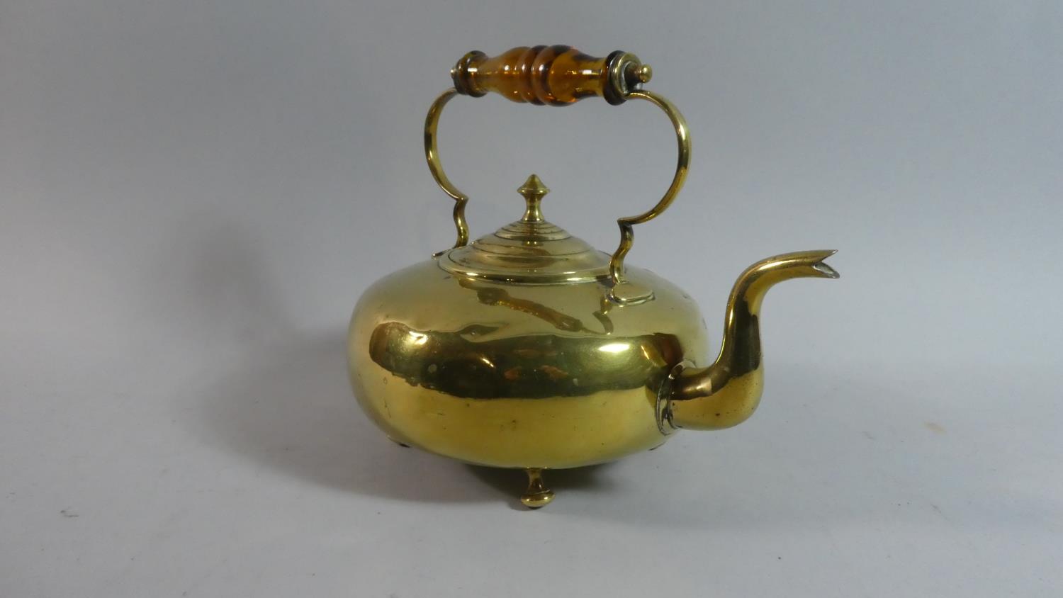 A Brass Kettle with Amber Glass Handle